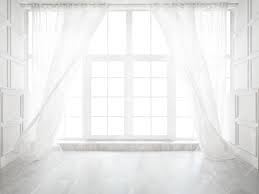 Backlit window with white curtains in empty room